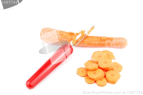 Image of Peeling a carrot with peeler on white