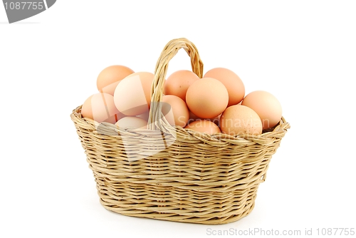 Image of Eggs in a wicker basket on white