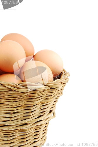 Image of Close-up of eggs in a wicker basket on white