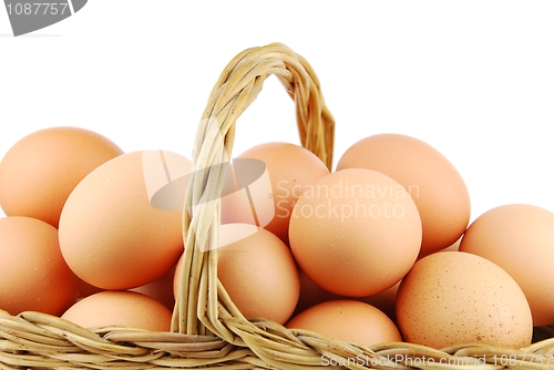 Image of Close-up of eggs in a wicker basket on white