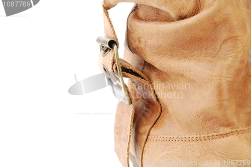 Image of Close-up of a women leather brown boot on white