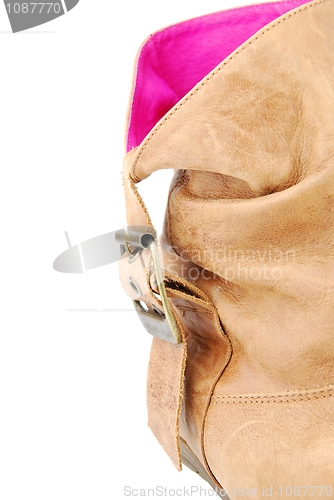 Image of Close-up of a women leather brown boot on white