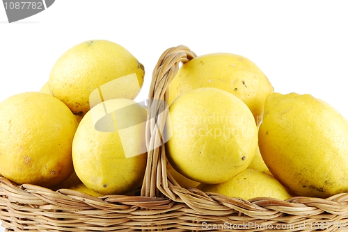 Image of Close-up of lemons in a wicker basket on white