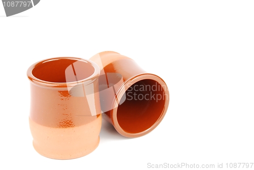 Image of Vibrant orange ceramic planting pots on white