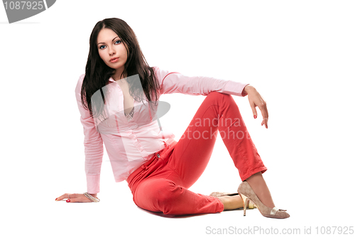 Image of Beautiful young woman in red jeans