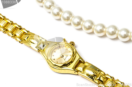 Image of Golden wrist watch and pearl necklace