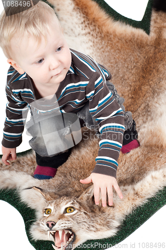 Image of Little boy on the lynx fur