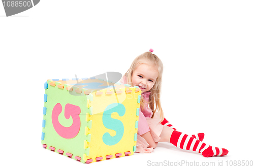 Image of Little girl playing with cube