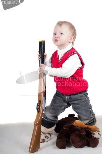 Image of Little boy playing with gun