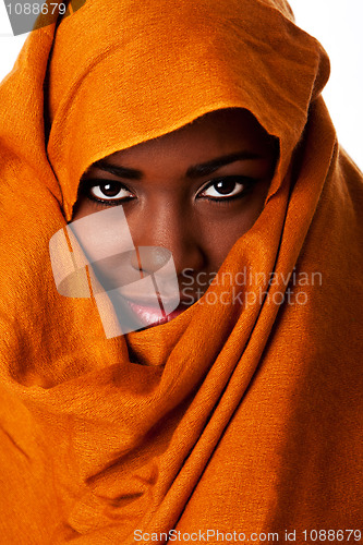 Image of Mysterious female face in ocher head wrap