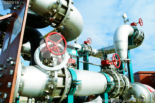 Image of Industrial zone, Steel pipelines and valves against blue sky