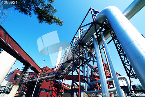 Image of Industrial zone, Steel pipelines and valves against blue sky