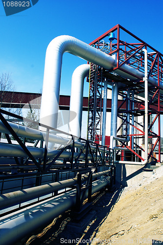 Image of Industrial zone, Steel pipelines and valves against blue sky