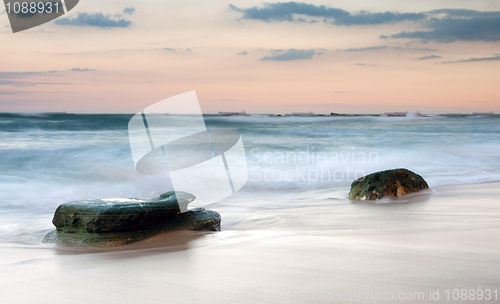 Image of water on rocks at sunset