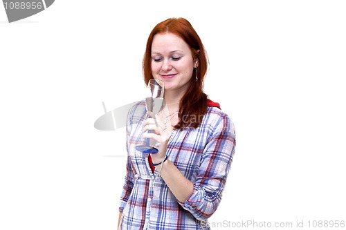 Image of Redhead young woman is drinking from glass