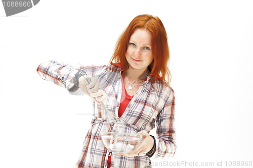 Image of redhead young woman cooks dinner