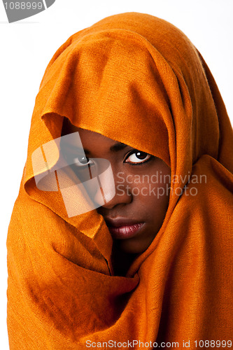 Image of Mysterious female face in ocher head wrap