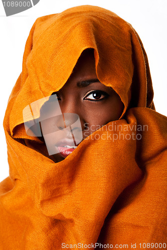 Image of Mysterious female face in ocher head wrap