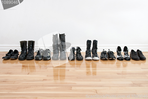 Image of Row of shoes and boots on a wooden floor