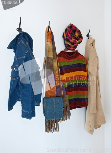 Image of Colorful clothing on coat hooks