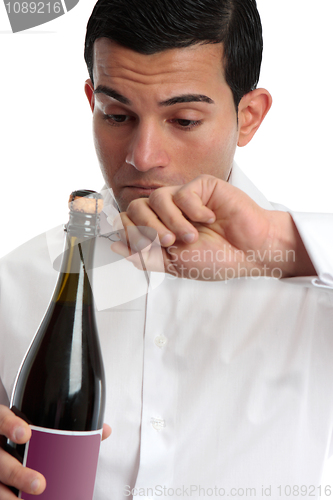 Image of Closeup man opening wine