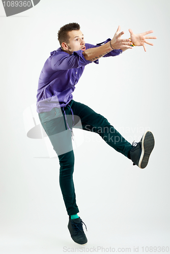 Image of handsome young man model jumping