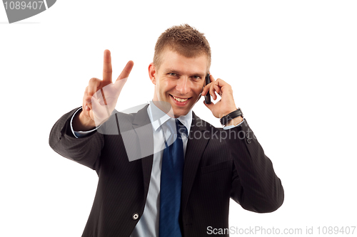 Image of  man making victory sign on phone