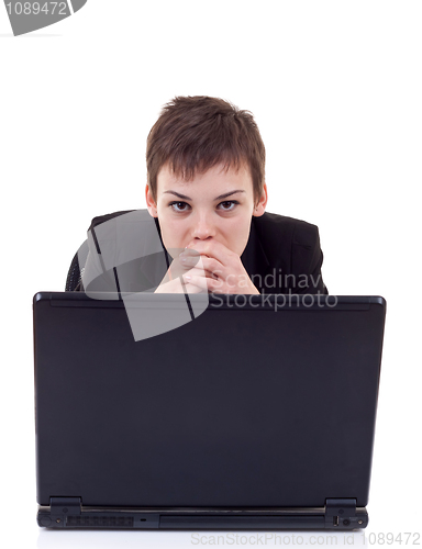 Image of pensive woman working on laptop