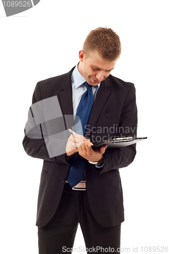 Image of man writing on his notepad 