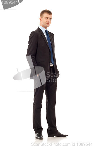 Image of business man with hands in pockets