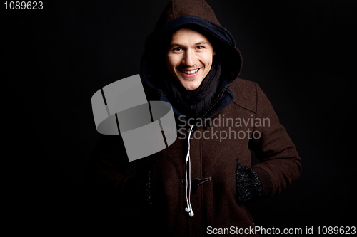 Image of fashion male portrait with a hodded coat