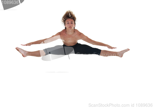 Image of ballet dancer jumping with spread legs