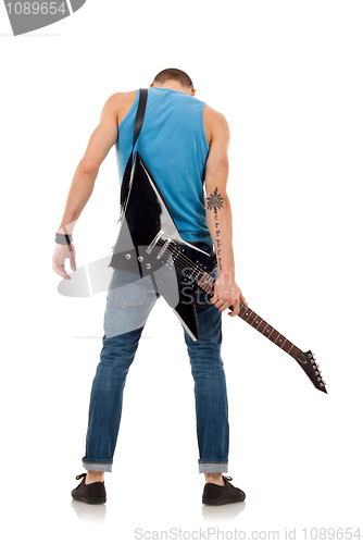 Image of guitar on back of a man