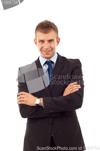 Image of business man stand with crossed hands 