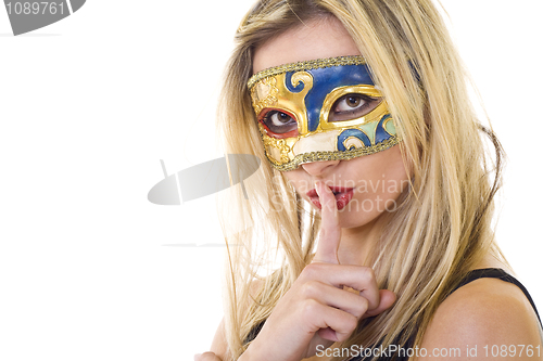 Image of masked woman making silence gesture 