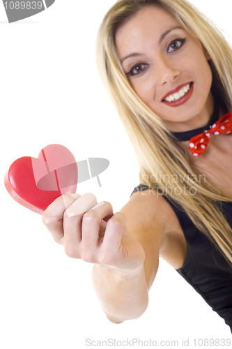 Image of  woman holding a big red heart and smiling