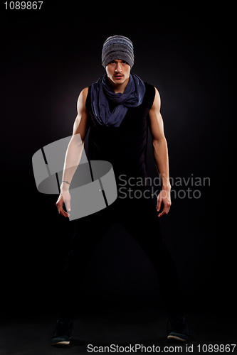Image of fashion guy wearing a hat and a scarf 