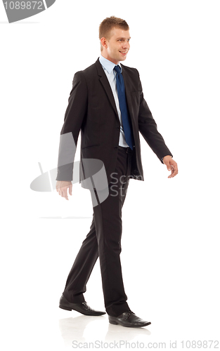 Image of young businessman is walking