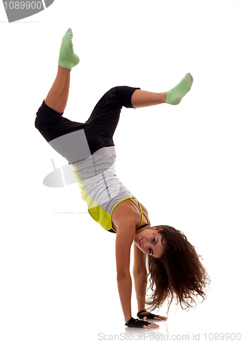 Image of sporty woman standing on hands