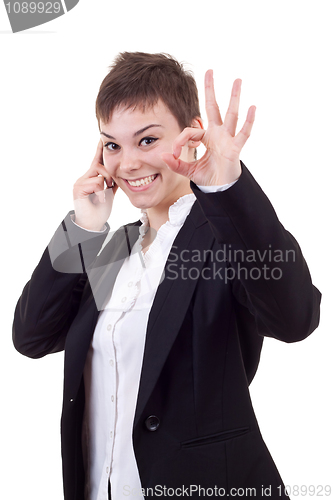 Image of  woman with phone making ok