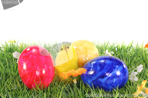 Image of Easter eggs and chicks on a meadow