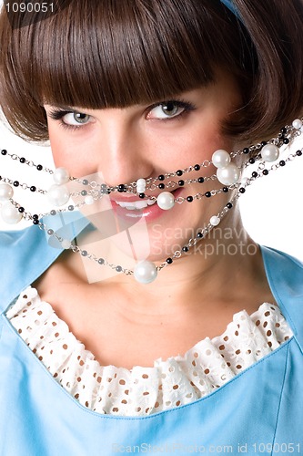 Image of brunet woman in blue dress with pearl beads