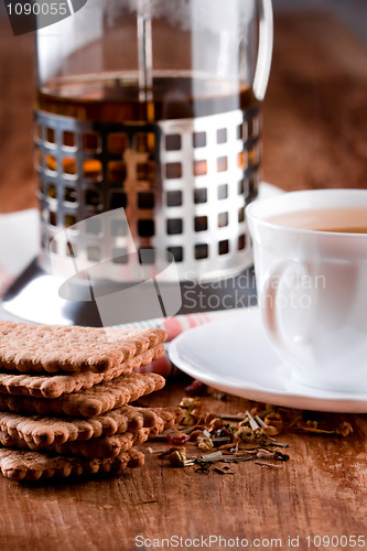 Image of french press, cup of herbal tea and some fresh cookies
