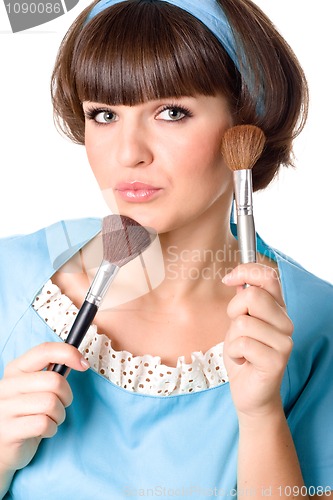 Image of brunet woman with two make-up brushes