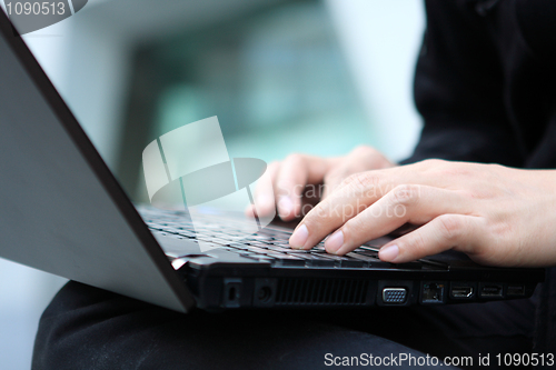 Image of young man works for a laptop 