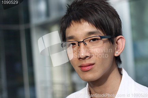 Image of Young businessman looking to good future on modern building back