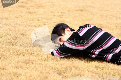 Image of Young man lying on grass 