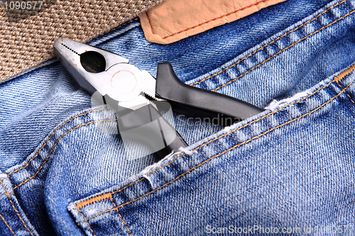 Image of pliers in the jeans' pocket