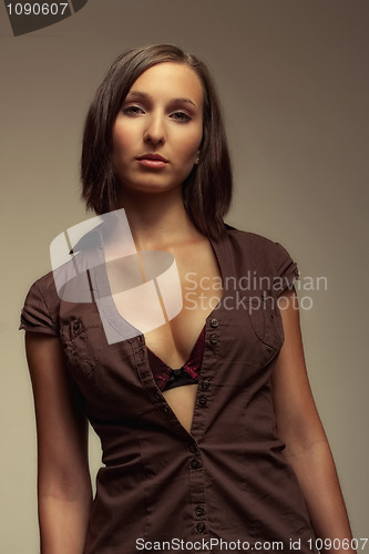 Image of attractive girl in brown shirt