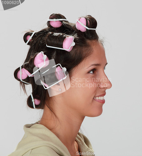 Image of Woman with hair curlers